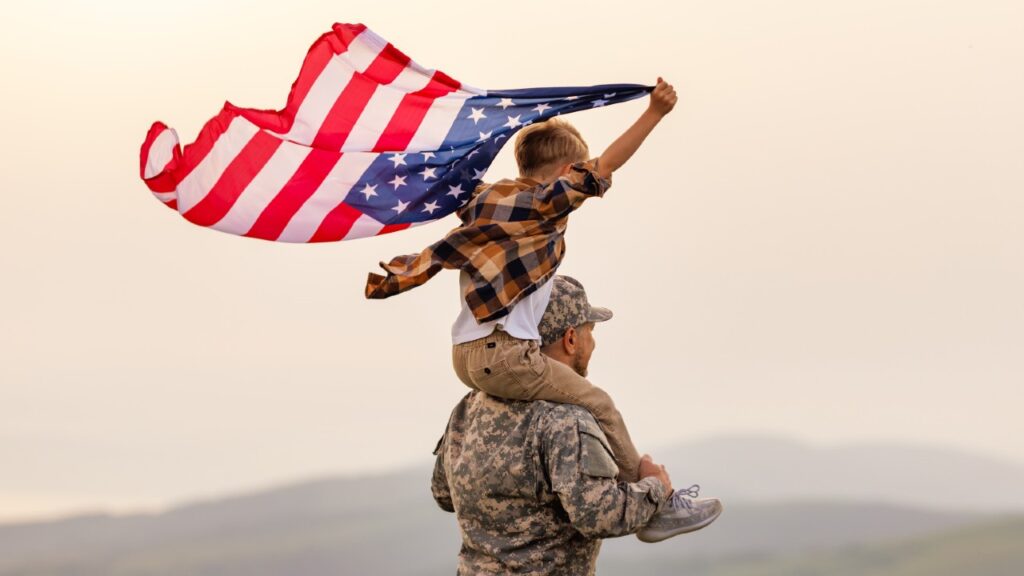 Military Dad, with child on shoulders.