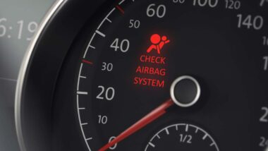 Airbag warning symbol displayed on a car dash, representing the Ford and Mazda airbags warning.