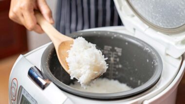 Close up of white rice being scooped out of a rice cooker, representing the Sunbeam class action.