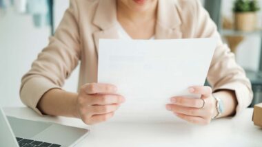 Close up of a woman reading a document, representing the CoreLogic Credco settlement.