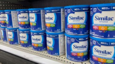 Close up of Similac products on a supermarket shelf, representing Similac baby formula lawsuit settlement.
