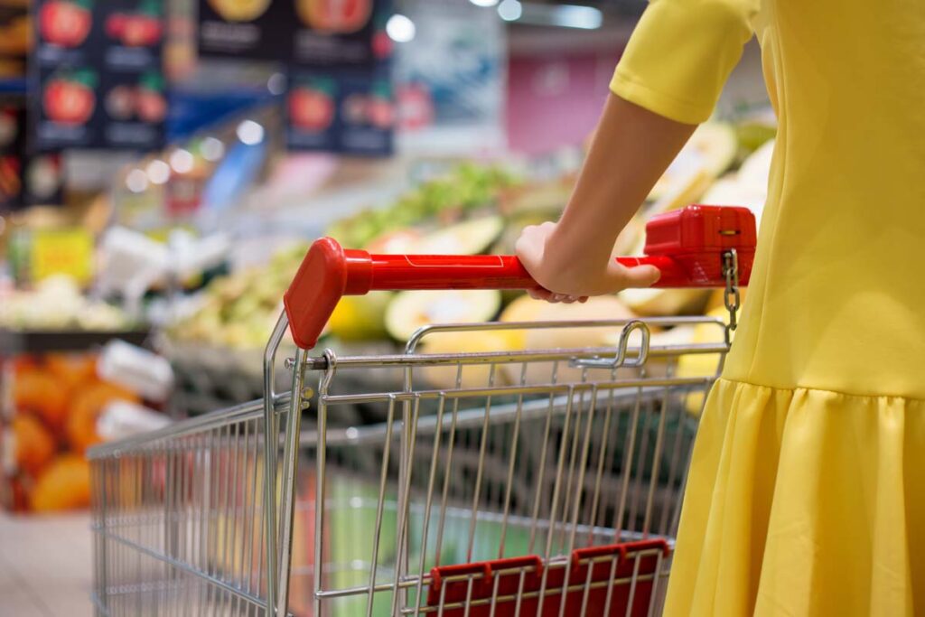 Close up of a woman pushing a shopping cart, representing top recalls for the week of July 29.