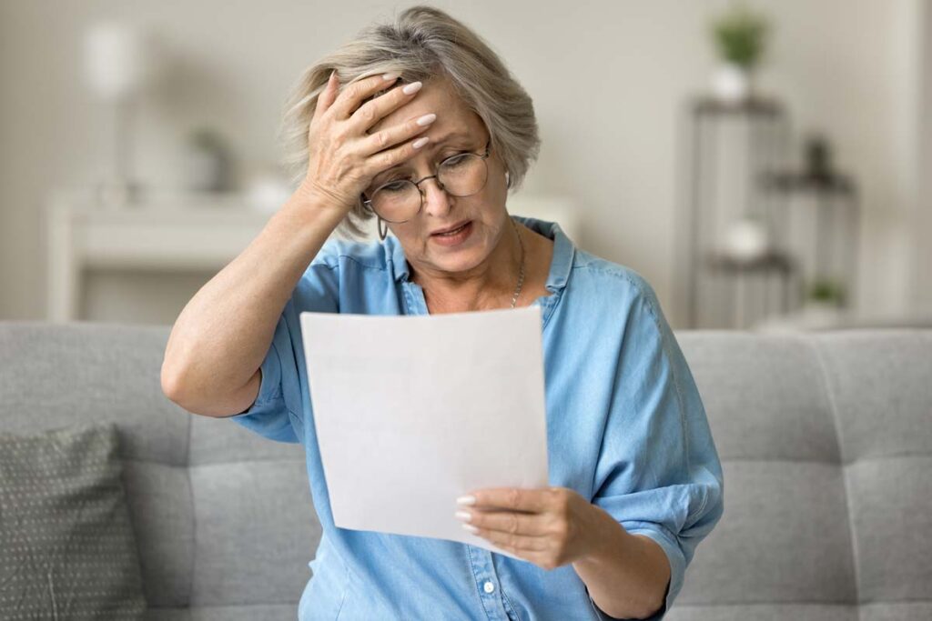 A stressed woman reading a paper, representing the LDF Holdings settlement.