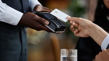 Close up of guest paying with credit card in luxury restaurant, representing the fee class actions.