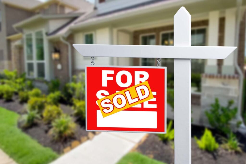 Sold sticker over a for sale sign, representing the NAR and HomeServices settlements.