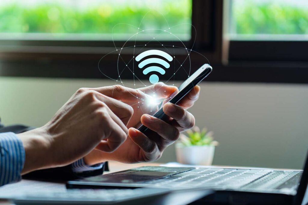 Close up of a man using a phone with a wifi symbol overlay, representing the Metronet class action.