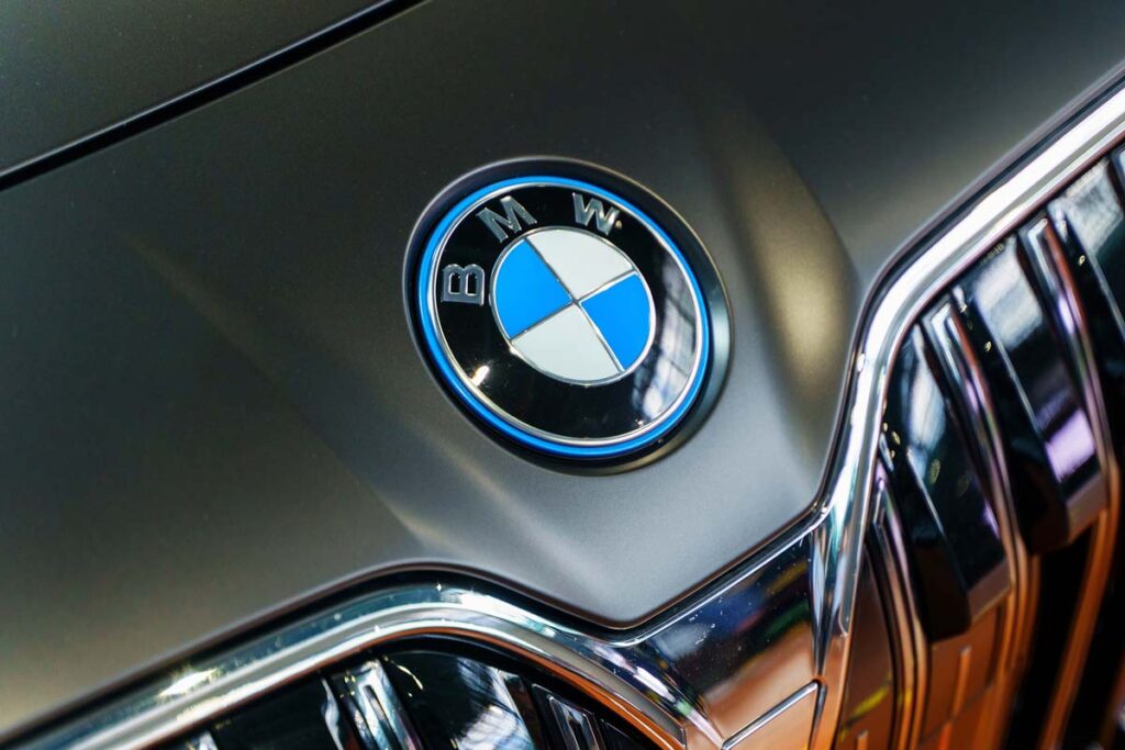 Close up of a BMW emblem on a front bumper, representing the BMW recalls and class action.