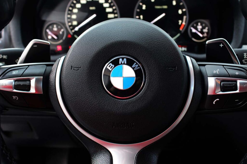 Close up of a BMW steering wheel, representing the BMW recall.