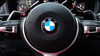 Close up of a BMW steering wheel, representing the BMW recall.