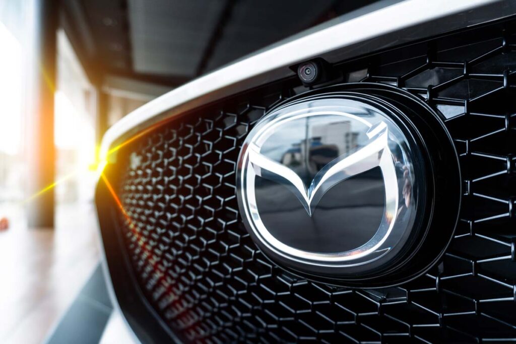 Close up of Mazda emblem on a front bumper, representing the Mazda class action.