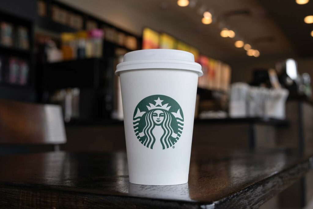 Close up of a Starbucks coffee cup sitting on a table, representing the Starbucks lawsuit.