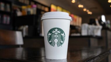 Close up of a Starbucks coffee cup sitting on a table, representing the Starbucks lawsuit.