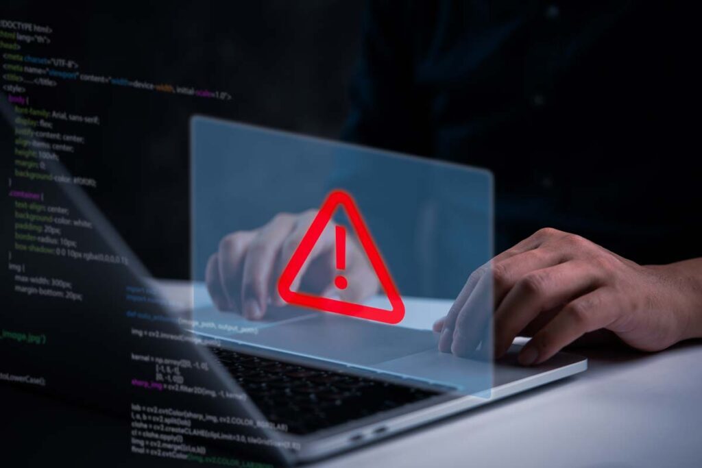 Close up of a man typing on a laptop with a data breach concept overlay, representing the National Public Data class action.