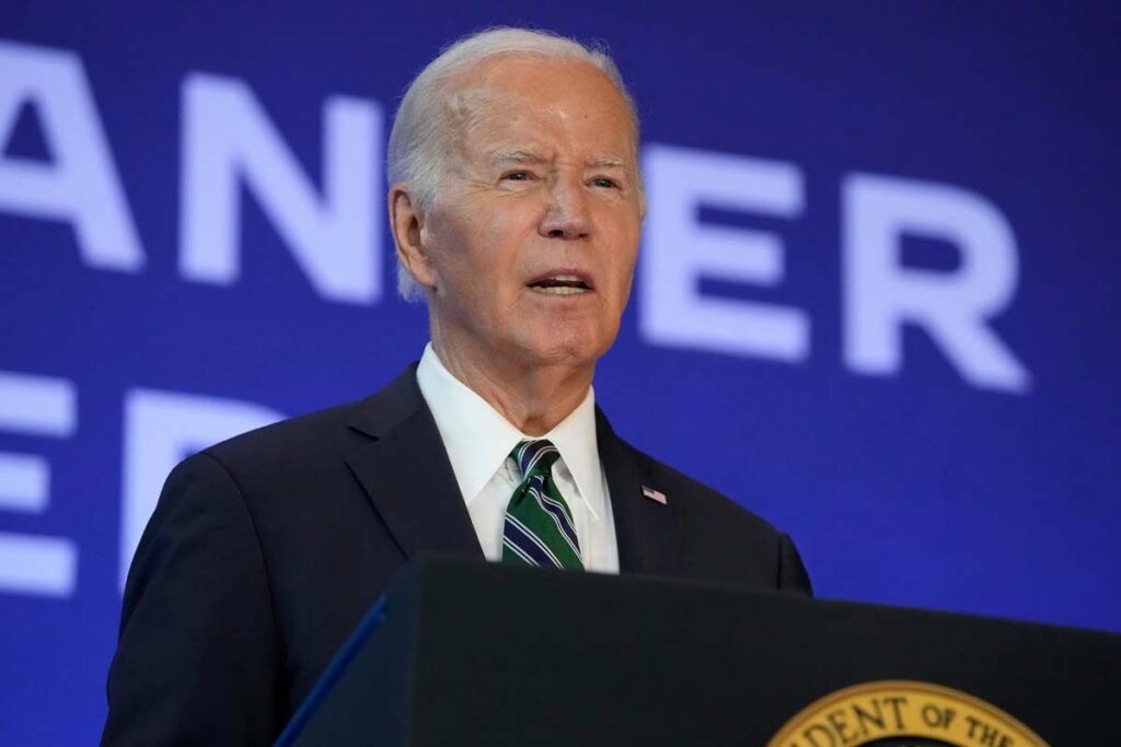 Joe Biden speaking at an event, representing the greed card lawsuit.