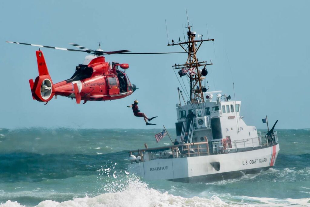 A coast guard ship and helicopter, representing the Coast Guard sexual assault allegations.