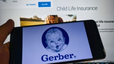 Gerber baby logo on cell phone screen in front of a computer representing the Gerber class action.