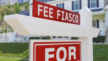 "Fee Fiasco" on a for sale sign in front of house.