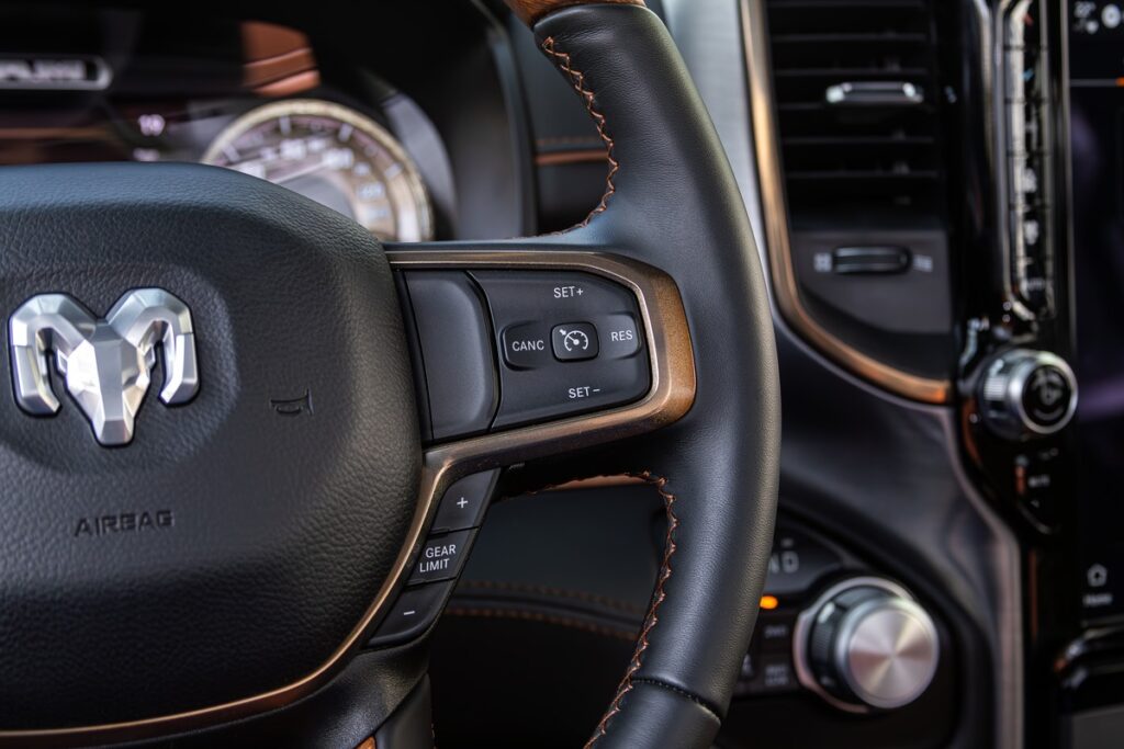 Dodge Ram 1500 steering wheel inside truck representing the Ram 1500 class action.