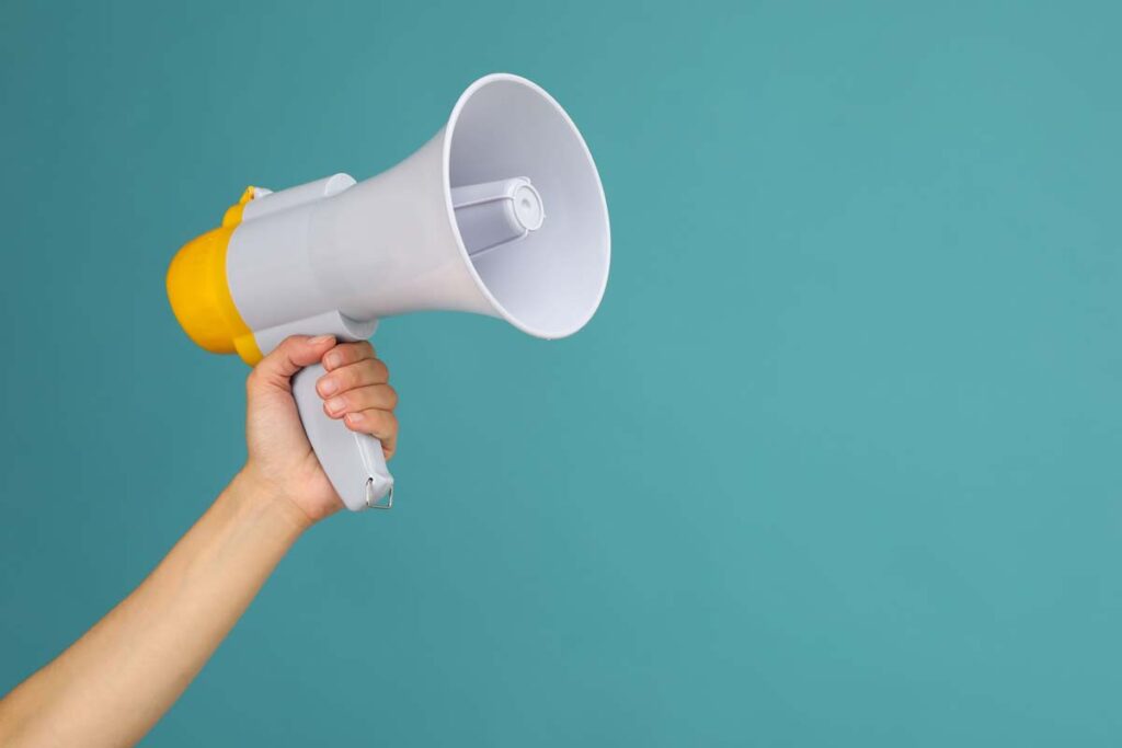 Close up of a hand holding a megaphone, representing top recalls for the week of Sept. 2.