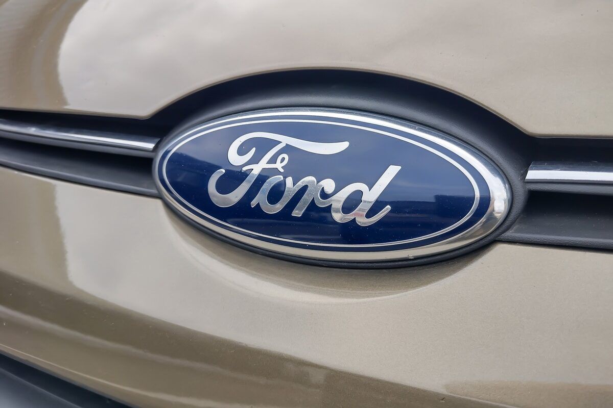 A Ford logo on a gold Ford car representing August auto recalls.