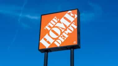 Close up of Home Depot logo sign with the blue sky background.