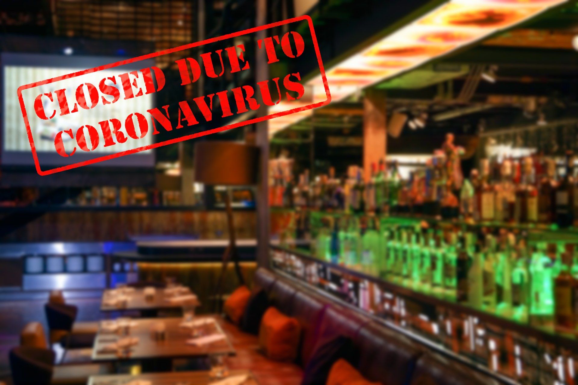 Blurred image of restaurant with red stamp overlaid in top left corner reading "CLosed Due To Coronavirus"
