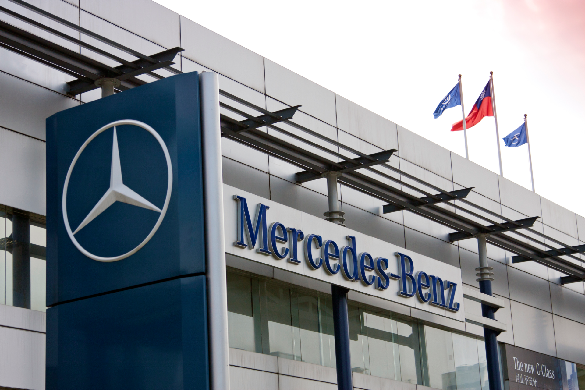 Signage and flags on a Mercedes-Benz dealership