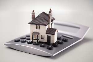 Model of house sitting on a calculator