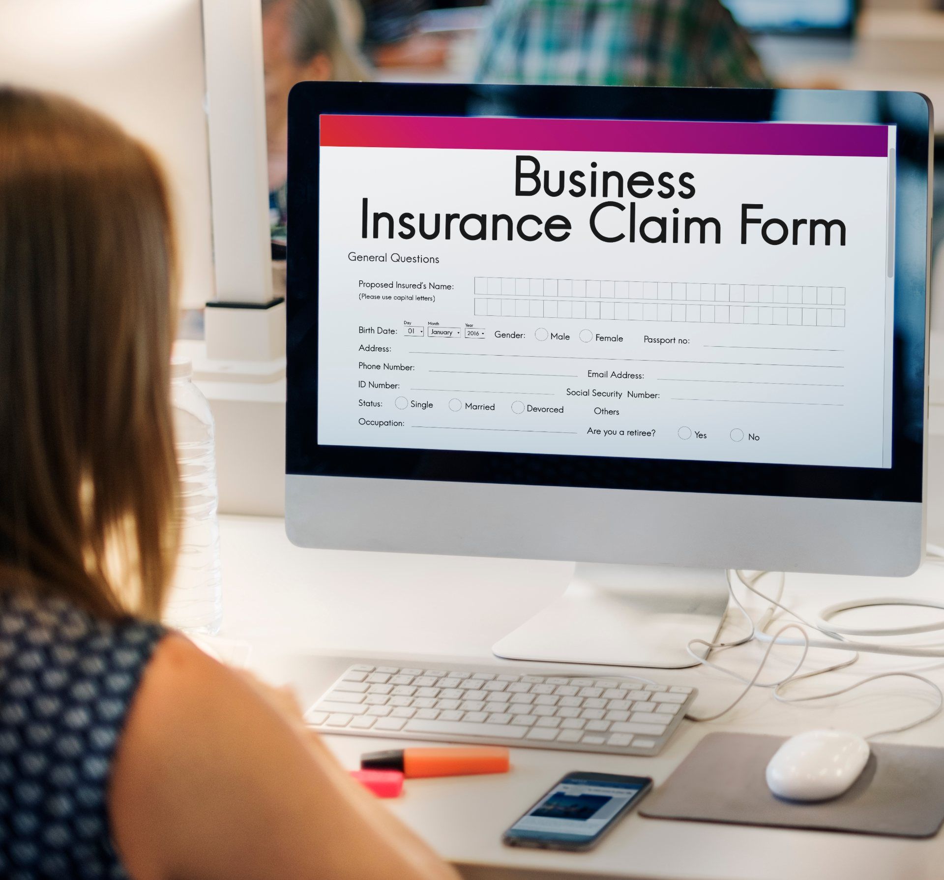 Woman uses computer to file business insurance claim form - Business interruption