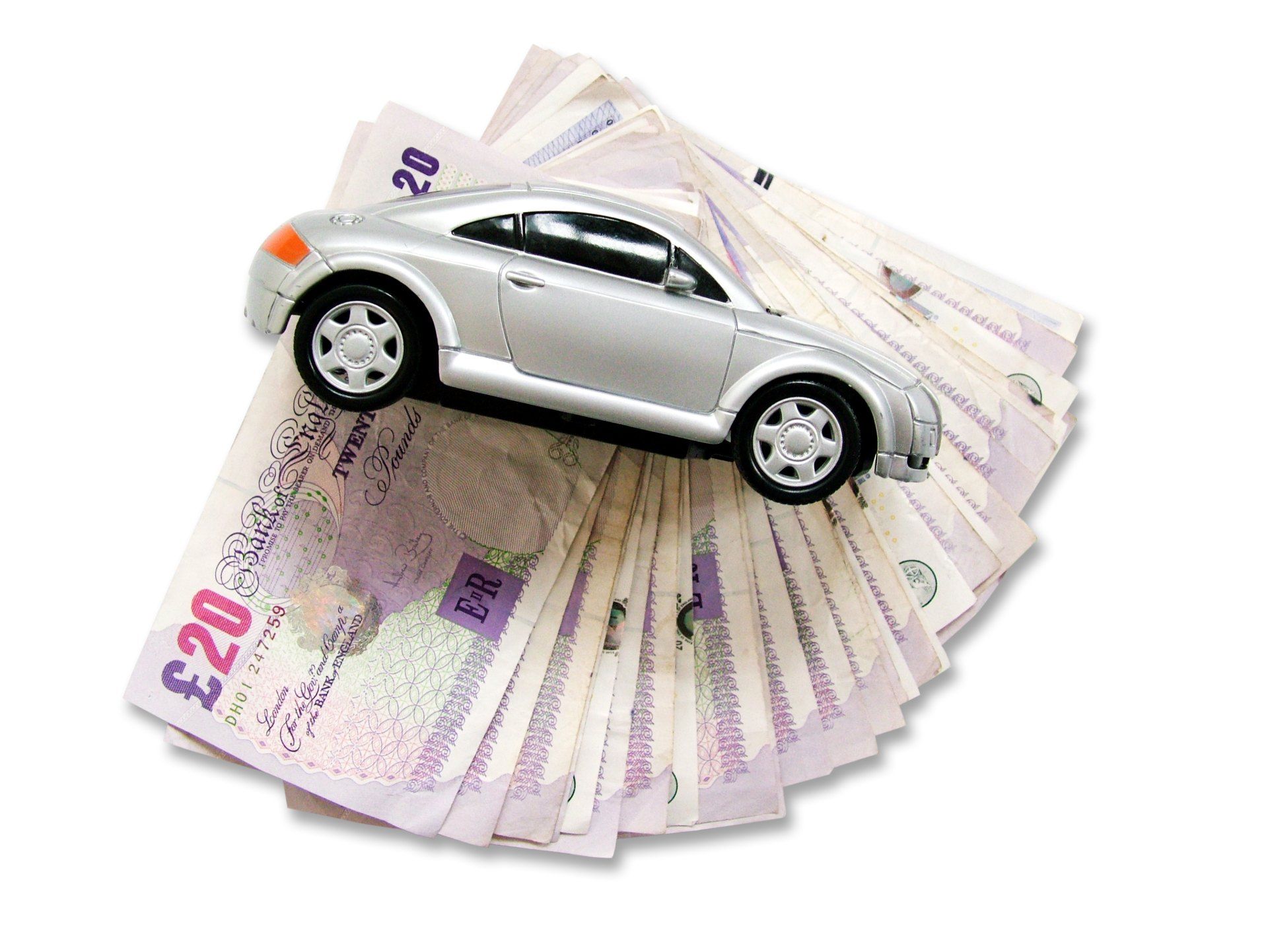 Model car on top of stack of British pounds - motor financing