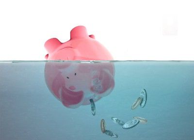 Drowning piggy bank with coins falling out - motor financing