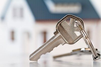 Closeup of keys with blurred house in background