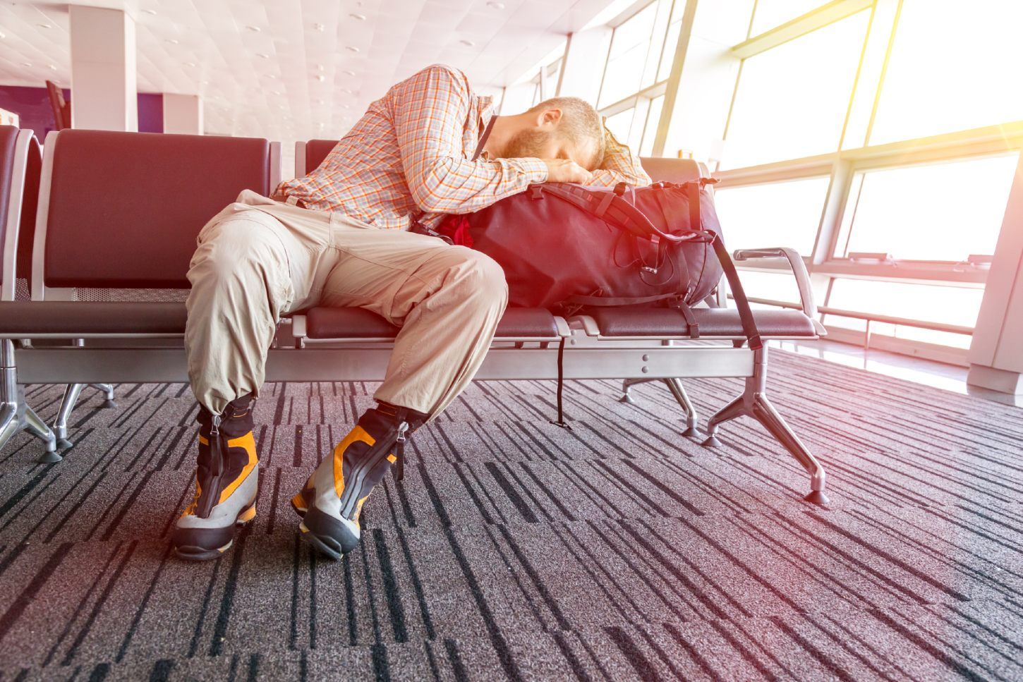 Man sleeping in seat at airport gate - cancelled flight