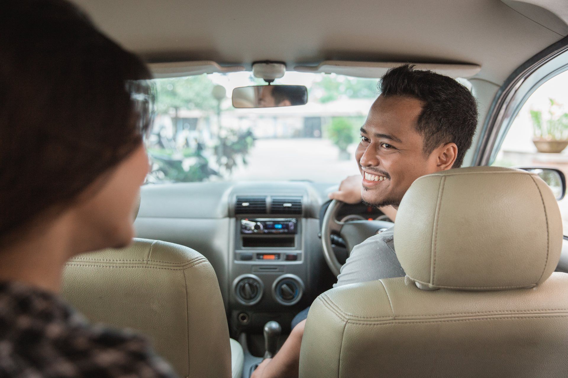 Rideshare driver welcomes passenger - Uber