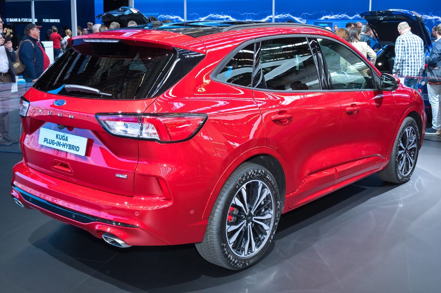 Red Kuga PHEV on on the floor of an auto show