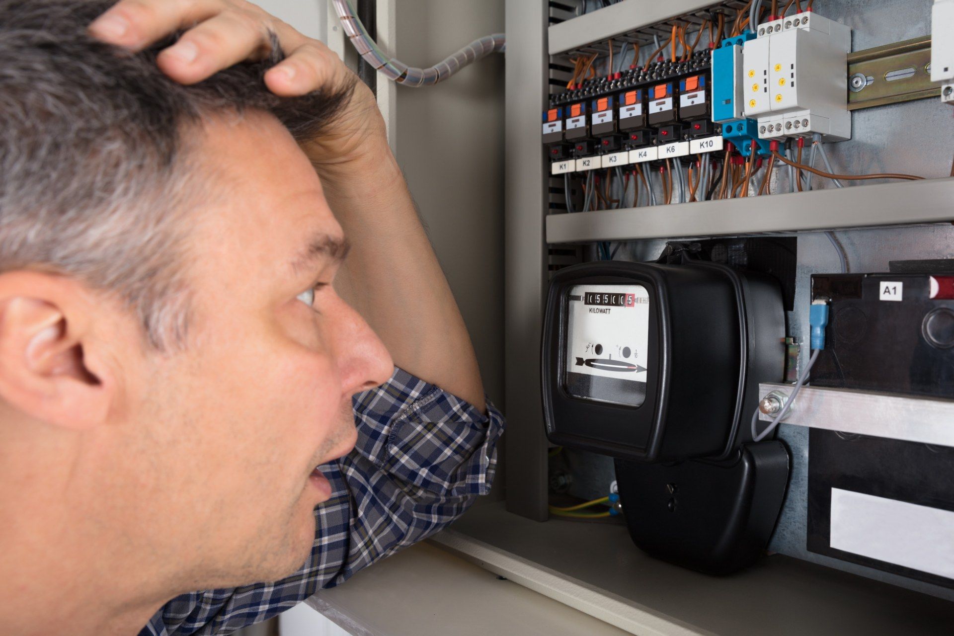 Man looks astonished while looking at electricity meter - British Gas