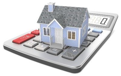 Model of a house sits on top of a desk calculator - mortgage holiday