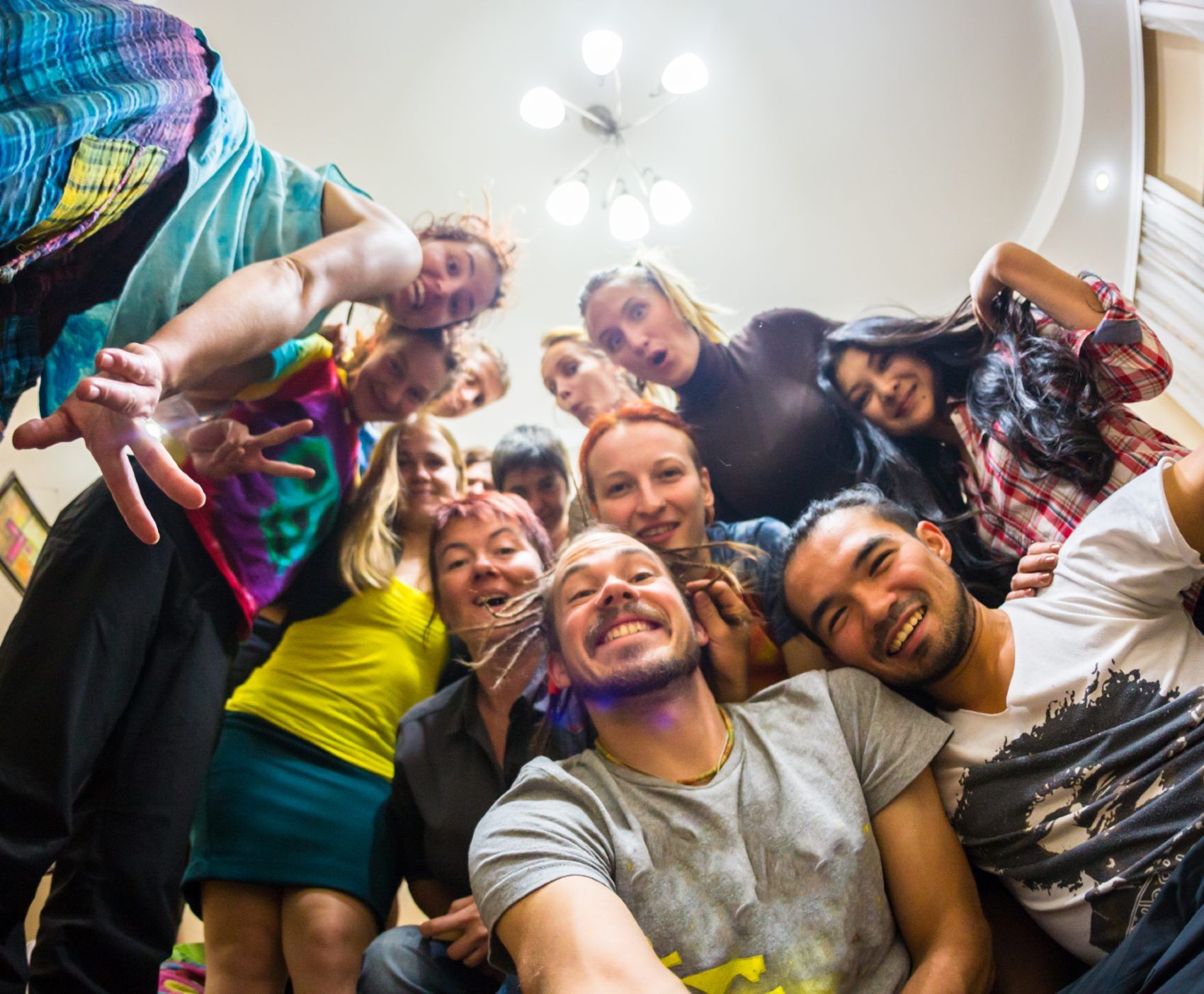 People take a group selfie at a house party - super-spreader events