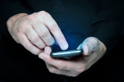 Man texts on smartphone - HSBC text scam