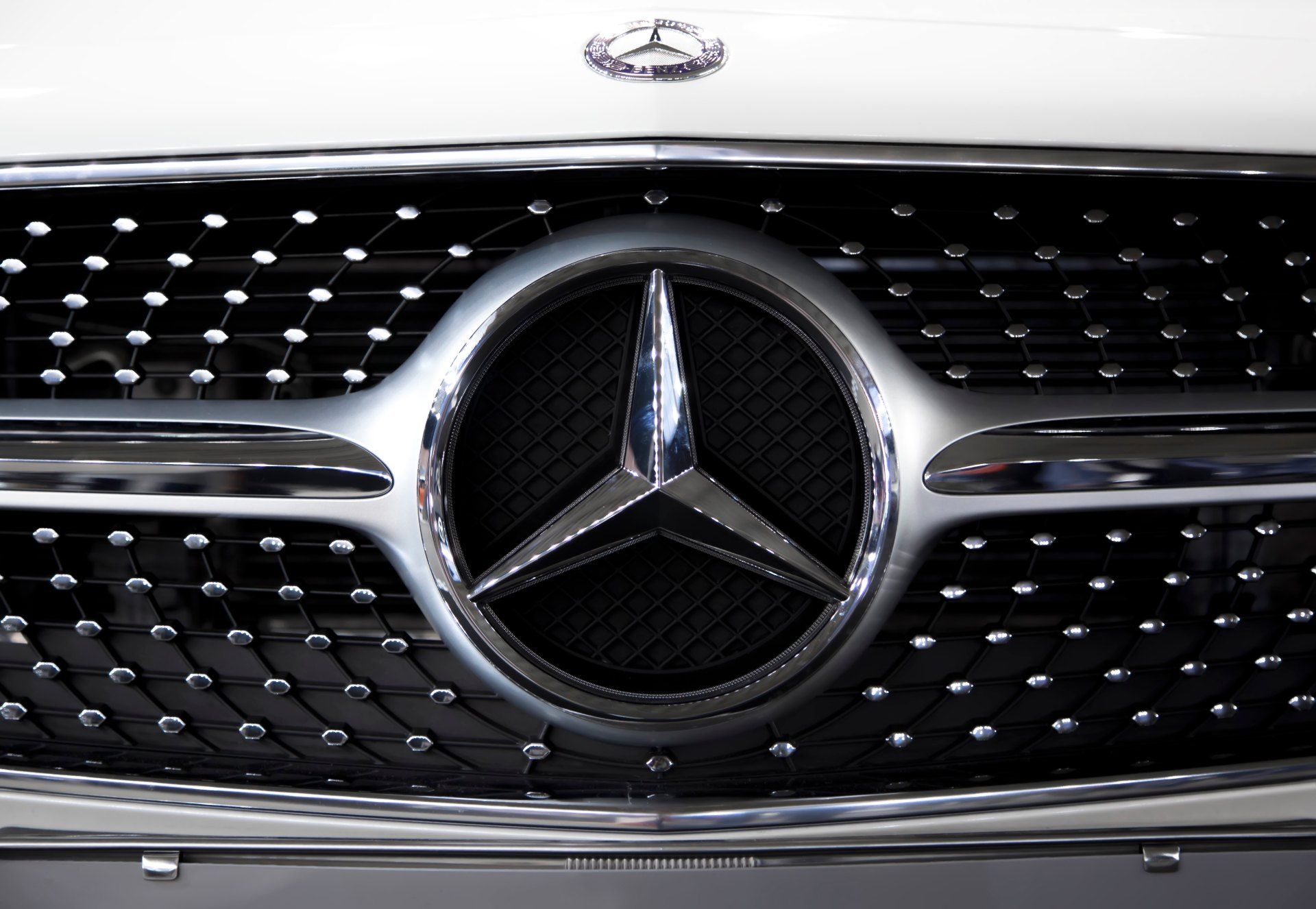 Mercedes logo on car grille - Mercedes group action