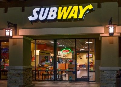 Subway restaurant storefront at night - subway bread