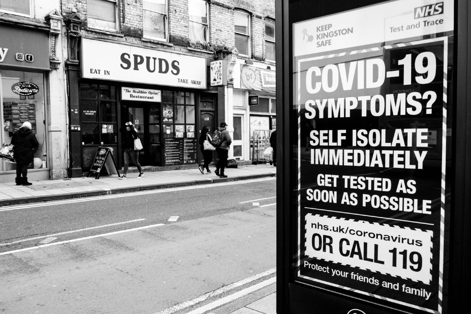 A sign on a UK street encourages people with COVID-19 symptoms to self-isolate immediately and get tested as soon as possible - test and trace data