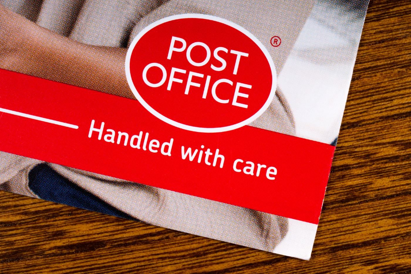 A card has the Post Office logo and says "handled with care" - post office horizon compensation