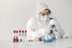 Biochemist looking at samples regarding the new strain of COVID