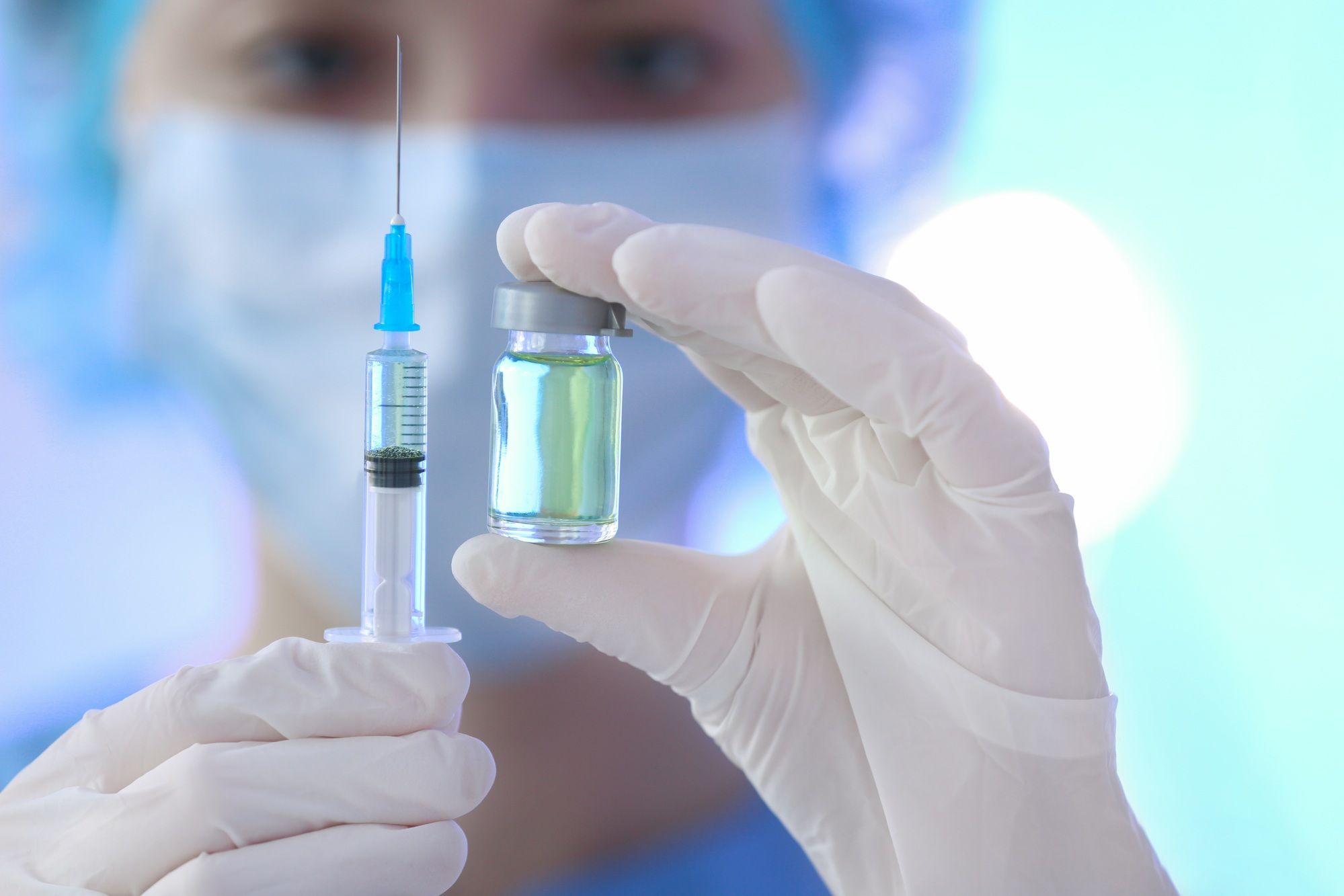 Nurse holding vaccine regarding the COVID-19 vaccine approved in UK