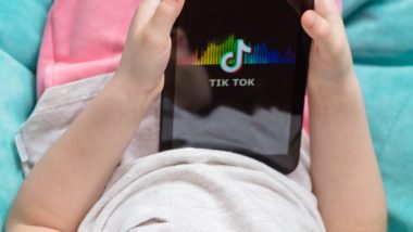 Child using TikTok app regarding the legal action being taken in UK