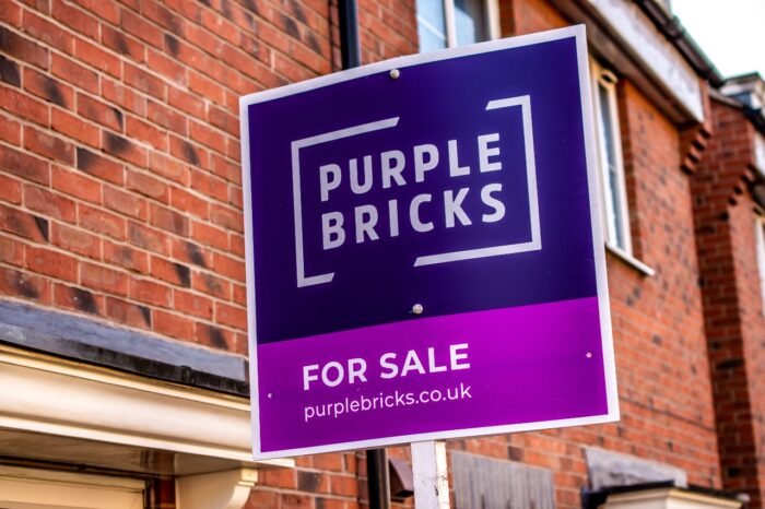 real-estate agents purple bricks sign showing the availability of a property for sale.