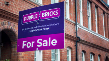 Purple Bricks estate agency 'for sale' sign board.