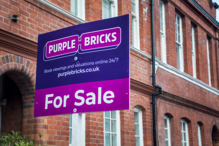 Purple Bricks estate agency 'for sale' sign board.