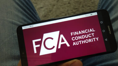Financial Conduct Authority (FCA) logo displayed on mobile phone.
